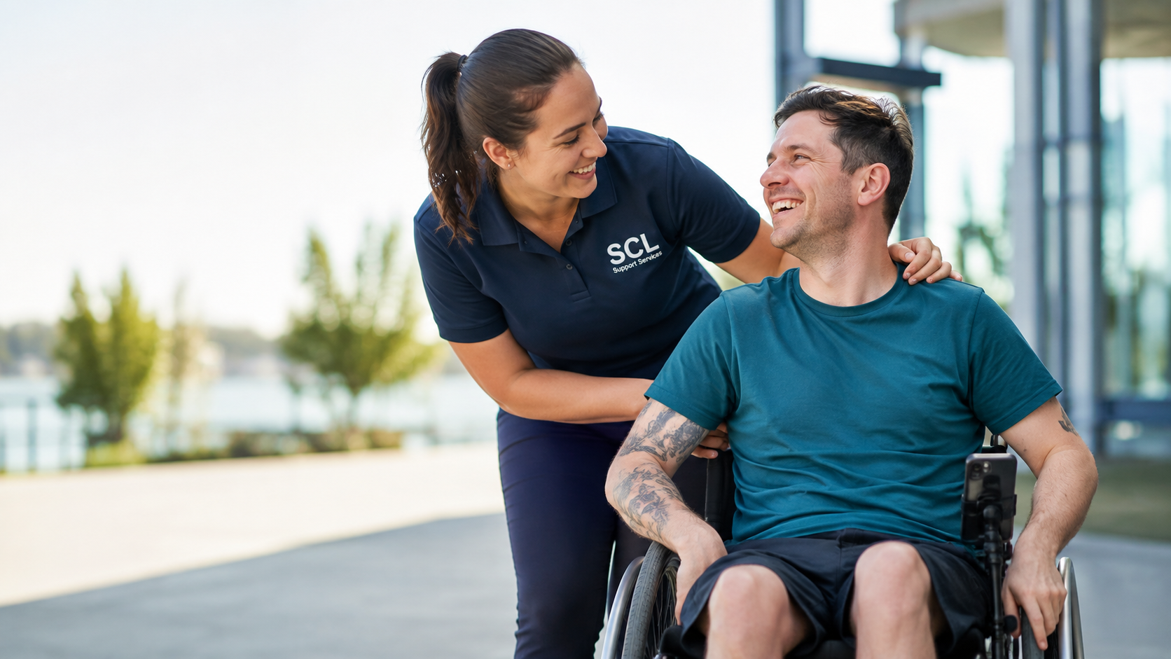 An SCL Support Services worker sharing a positive moment with a participant using a wheelchair
